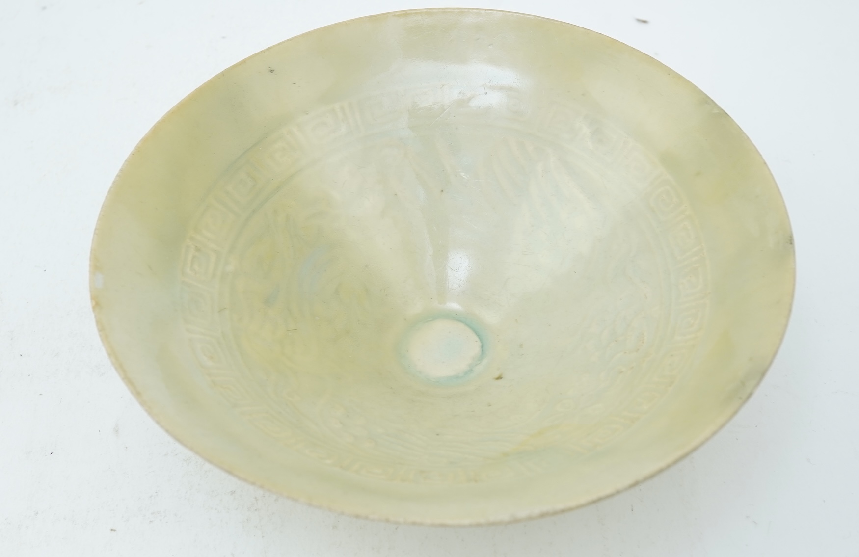 A Chinese Ding type circular dish, Song dynasty and a qingbai moulded conical bowl, Song-Yuan dynasty